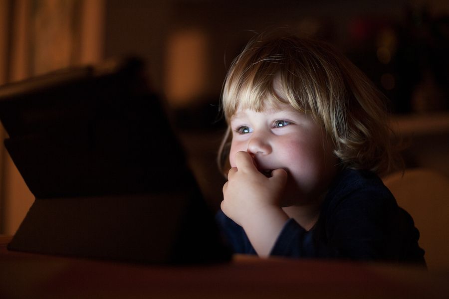 bigstock Smiling Baby Face Watching Scr 163699535