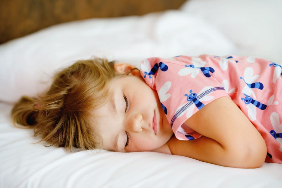 Cute Little Toddler Girl Sleeping In Bed. Adorable Baby Child Dreaming, Healthy Sleep Of Children By