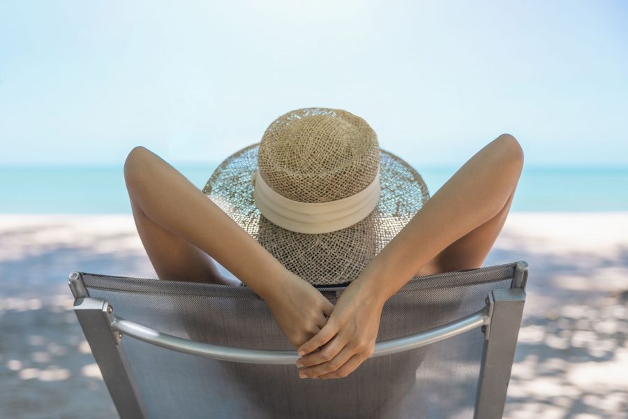 Model Asian Woman Wearing Red Swimsuit And Straw Hat Lying On The Sun Lounger In Sun By The Sea. Bea