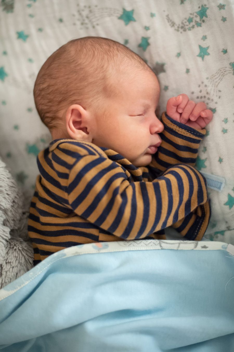 Cute Little Peaceful Baby Calm Sleeps Soundly In His Crib In A Bright Room. Close-up Portrait Of Bea