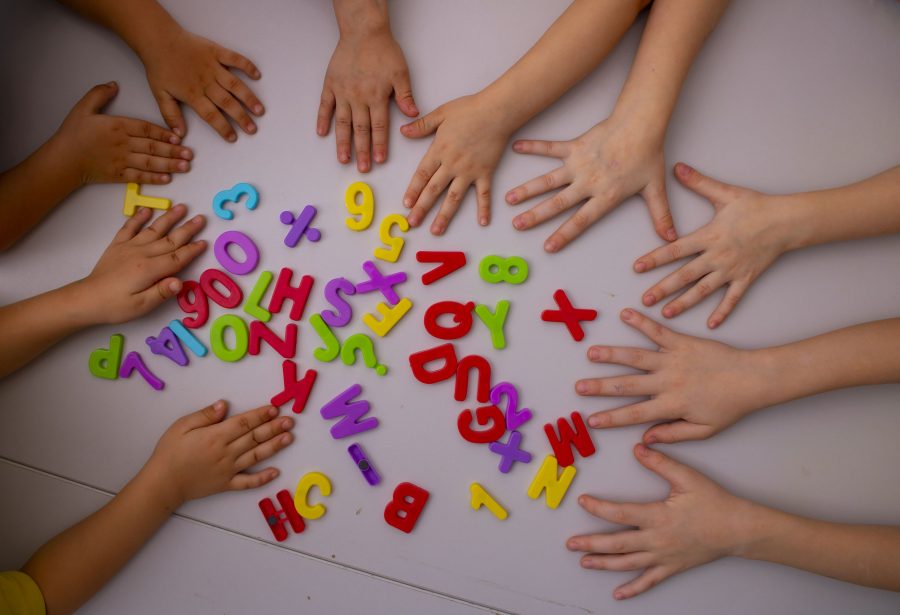 Kids Hands And English Letters. Top View, Learning Concept