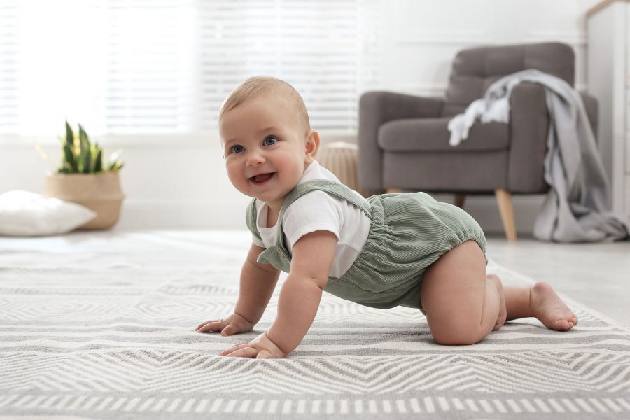 Cute Baby Crawling On Floor At Home