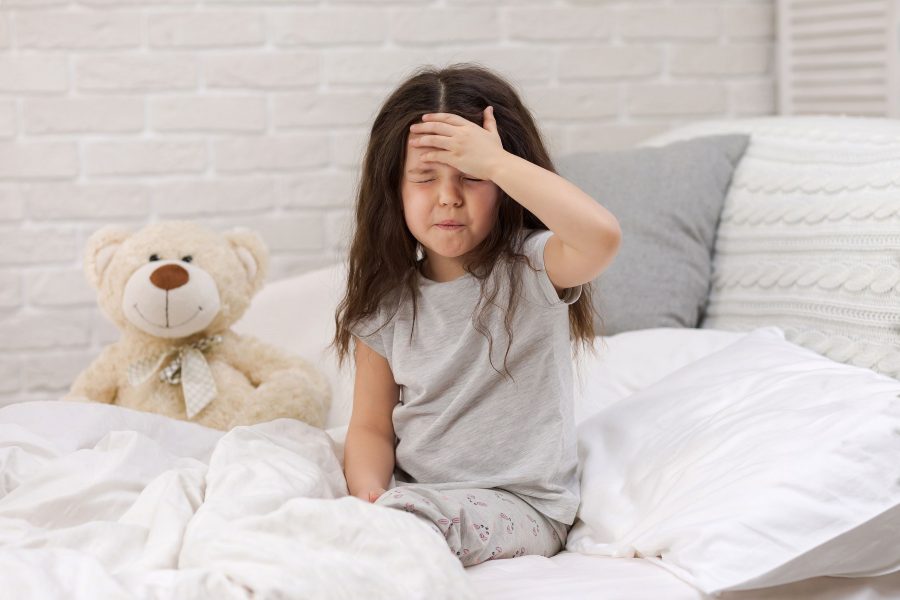 Sick Little Child Girl Lying In Bed. Cold Flu Season. Headache